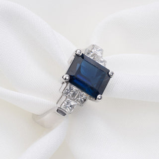 18ct White Gold 2.5ct Sapphire & 0.75ct Princess Diamond Trilogy Ring